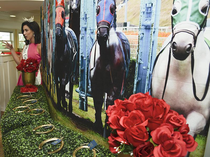 Miss Delaware Hillary May greets guest next to a derby display.